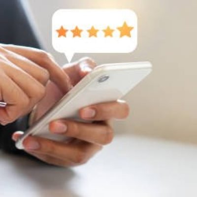 close up on customer man hand pressing on smartphone screen with  five star rating feedback icon and press level good rank for giving best score point to review the service , technology business concept